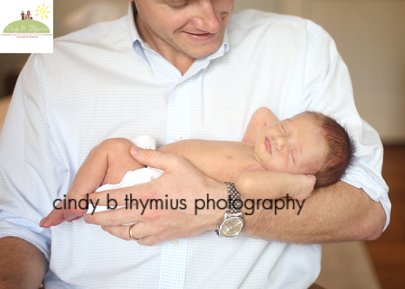 dad holding newborn baby in arms memphis