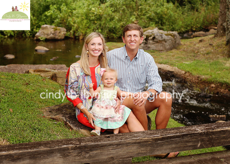 family portrait by creek at spring creek ranch