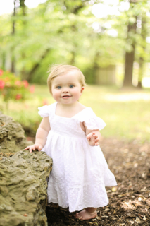 A small girl wearing white dress