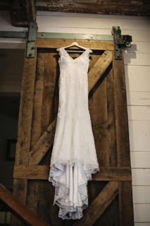 A gown hanging from a wooden wall
