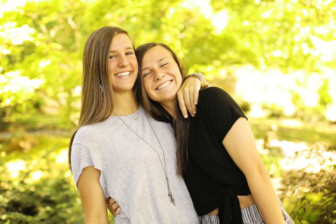 Two girls holding each other and smiling