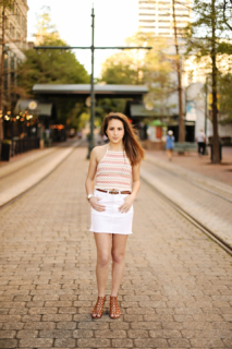 A girl wearing white standing in the middle of th road