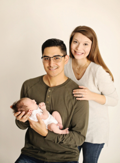 A couple holding their newborn baby