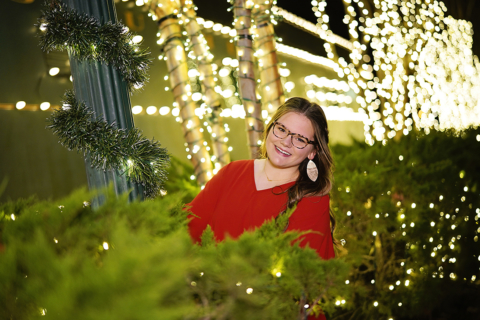 A lady surrounded by lights during Christmas