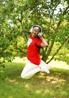 A girl wearing red shirt jumping in the air