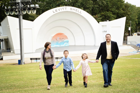 A family of four in front of levitt shell