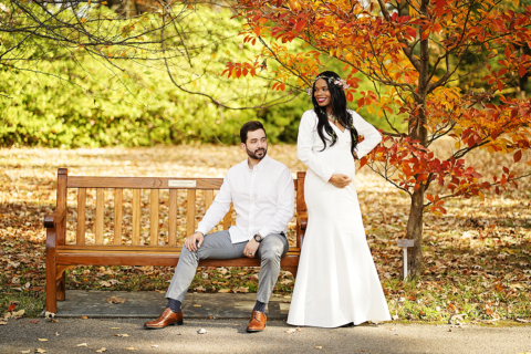 A couple posing wearing white cloths