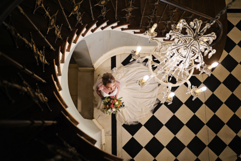 A bride holding flowers near the stairs