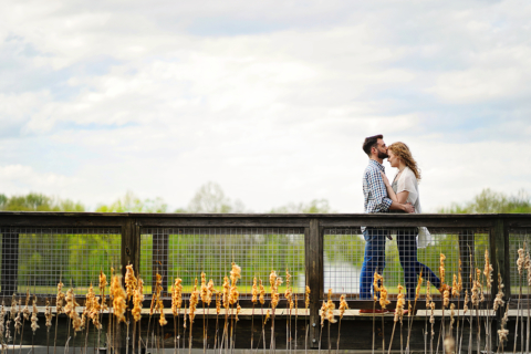 A man and a woman standing on bridge