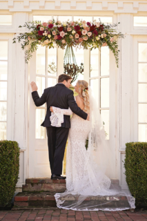 A bride and groom opening a gate