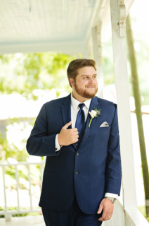 A groom standing on the porch