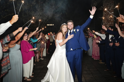 A bride and groom being celebrated with sparkles