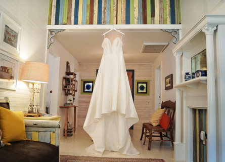 A beautiful white gown hung from a ceiling