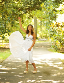 A woman in white dress standing on the road