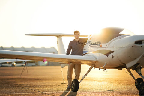 Sunset on horizon with high school senior boy and an airplane in Memphis, TN